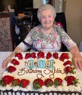 The late Sylvia Hoy celebrating her 101st birthday with a large cake.
